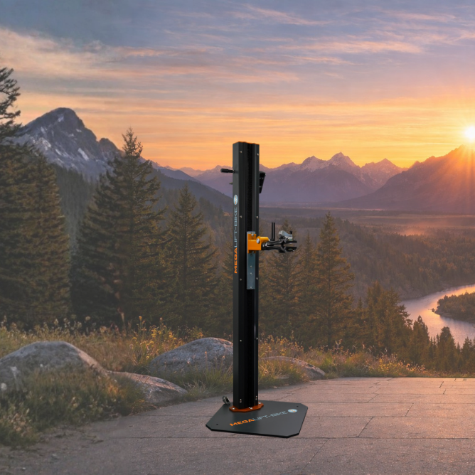 Electric bike repair stand for workshop use Electric bike repair stand on base in front of mountain landscape at sunrise